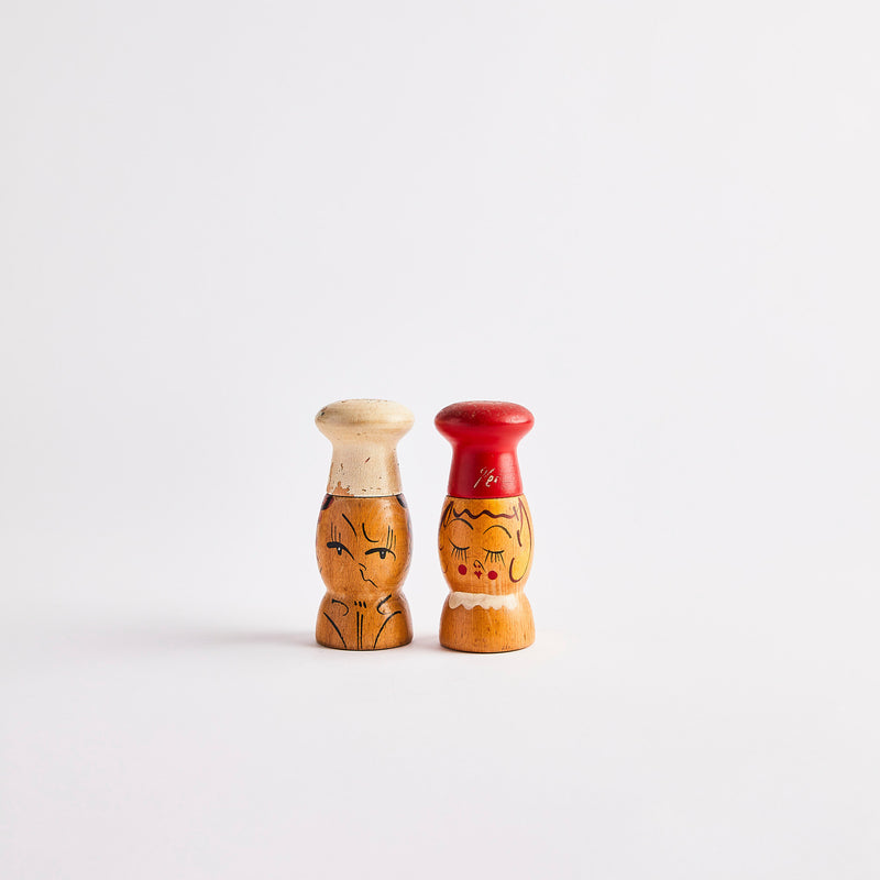 Two wooden chef shakers.