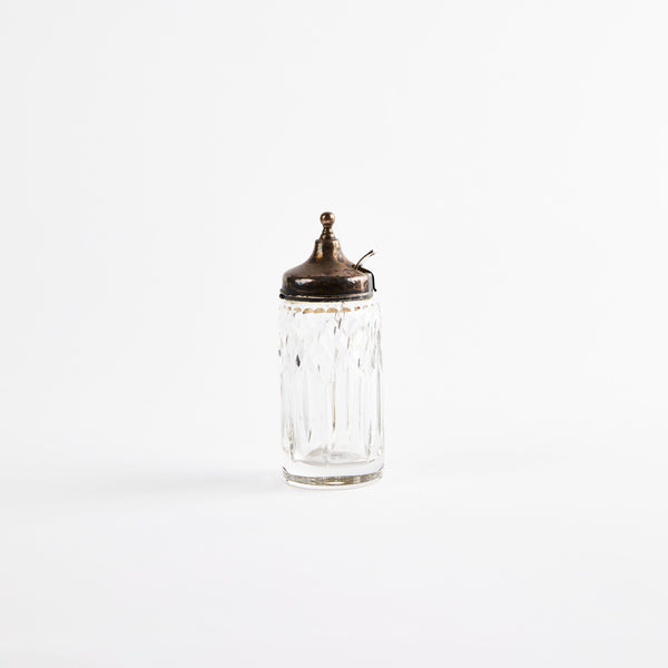 Clear glass shaker with silver metal top.