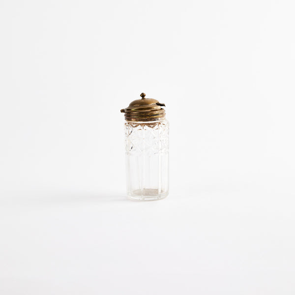 Clear glass shaker with metal top.