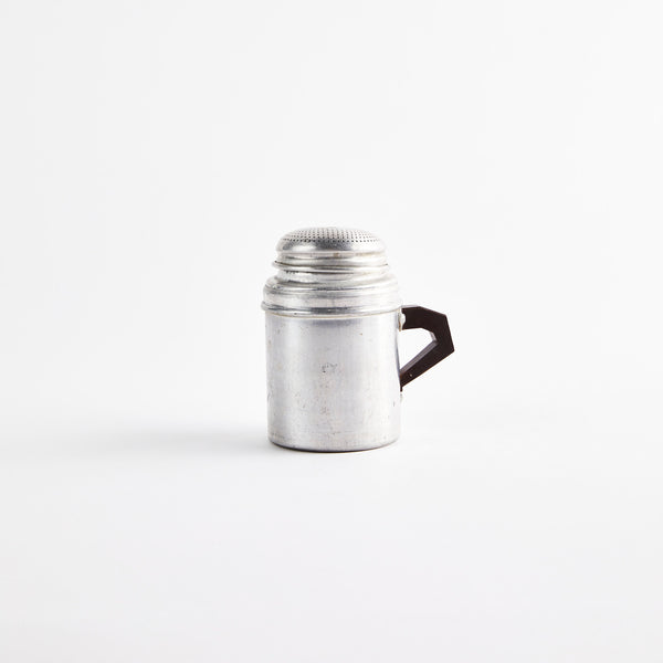 Silver shaker with black handle.