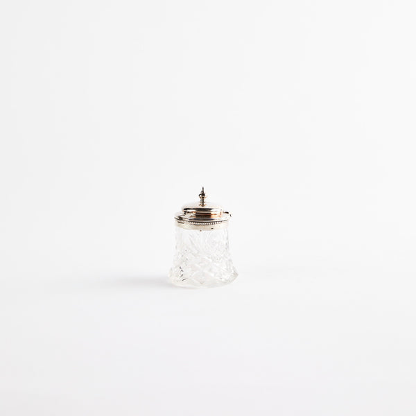 Clear glass shaker with metal top.