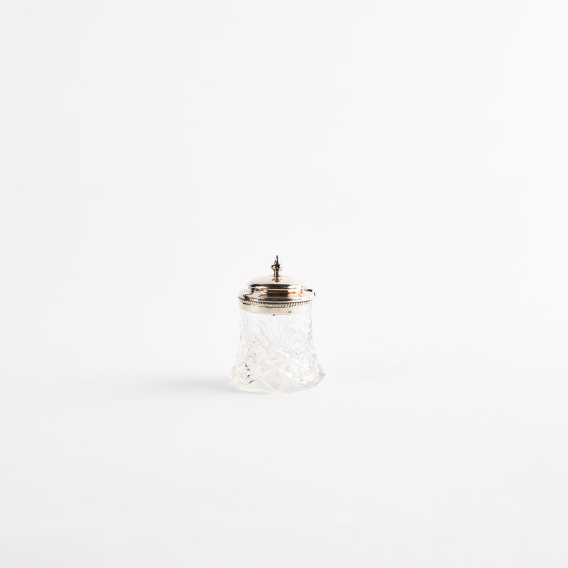 Clear glass shaker with metal top.