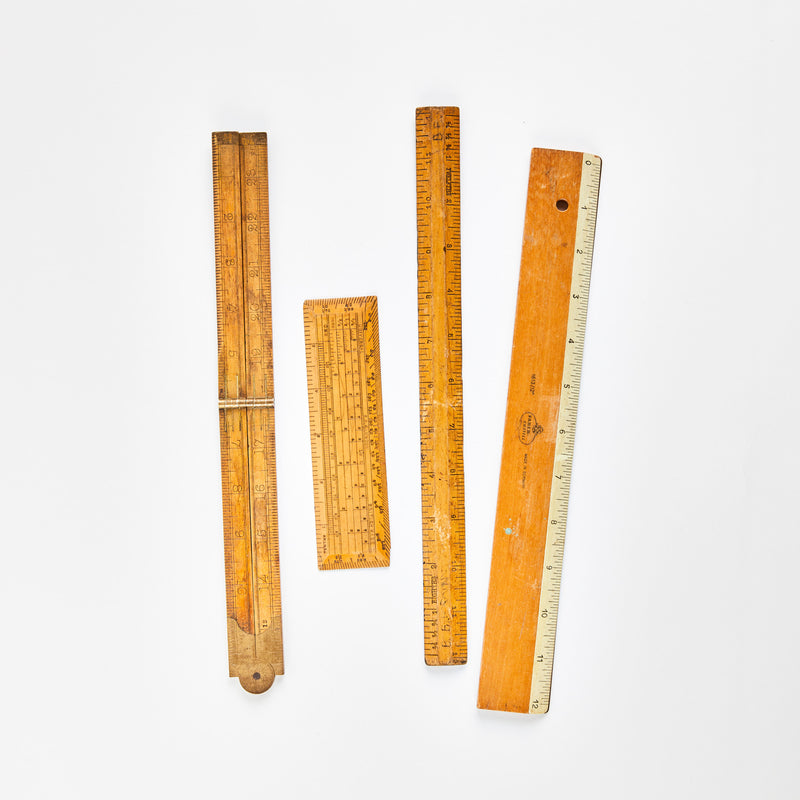 Four wooden rulers.