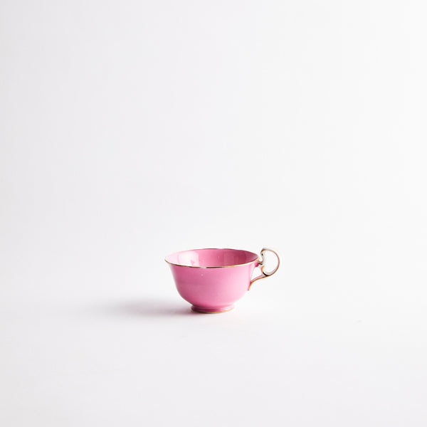 Pink teacup with gold detailing.