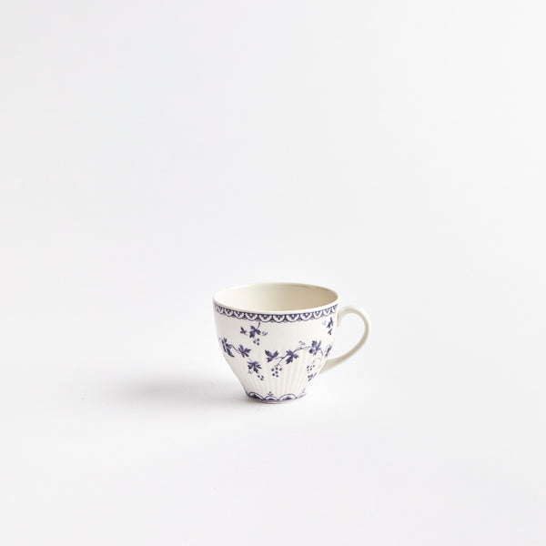 White teacup with blue flowers.