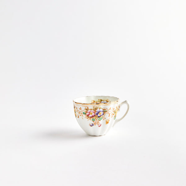 White teacup with multicolour flowers.