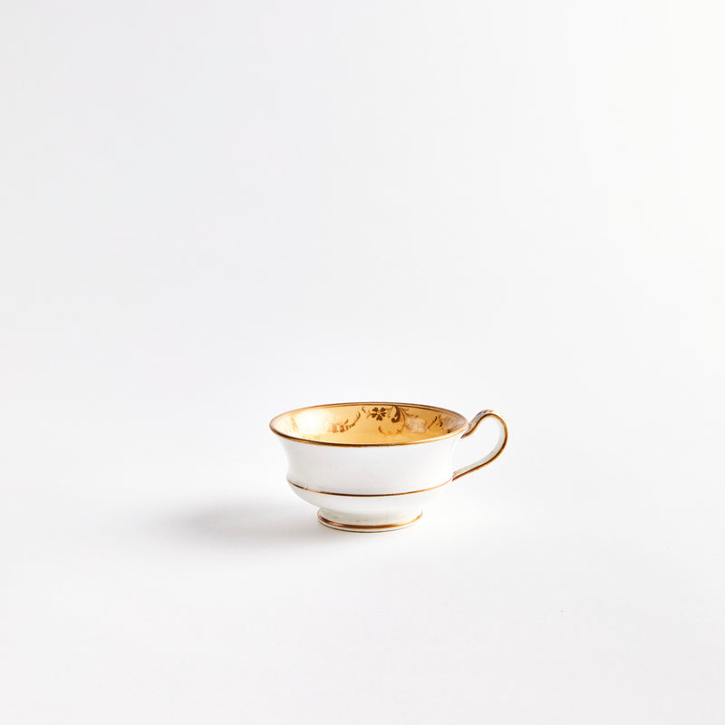 White teacup with gold detail.