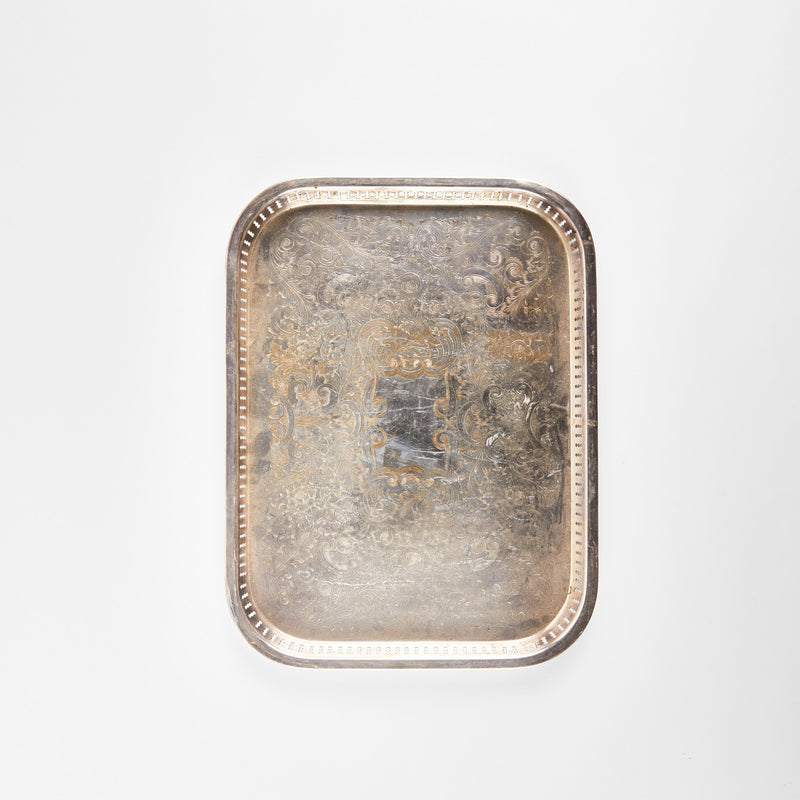Rectangular silver tray with etched design.