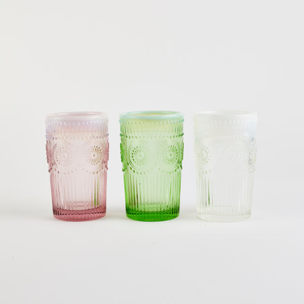 Three glass embossed design tumblers (pink, green and white).