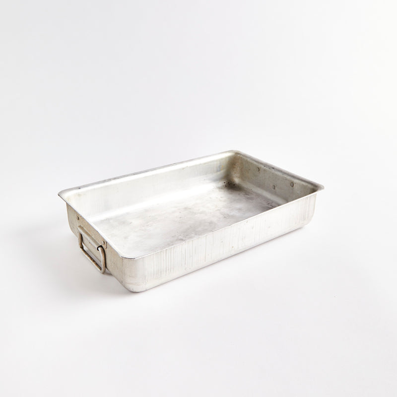 Silver metal tray with handles.