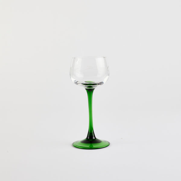 Wine glass with green stem.