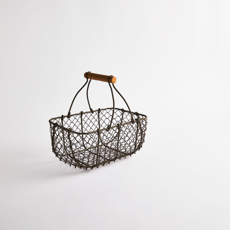 Grey wire basket with wooden handle.