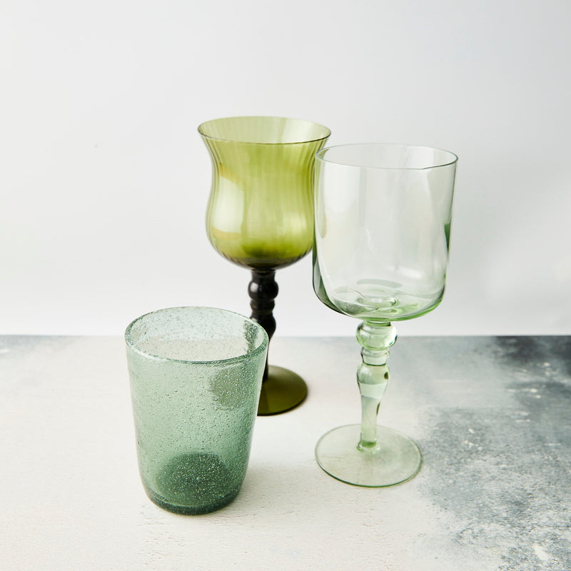 Mixed green wine glasses and tumbler.