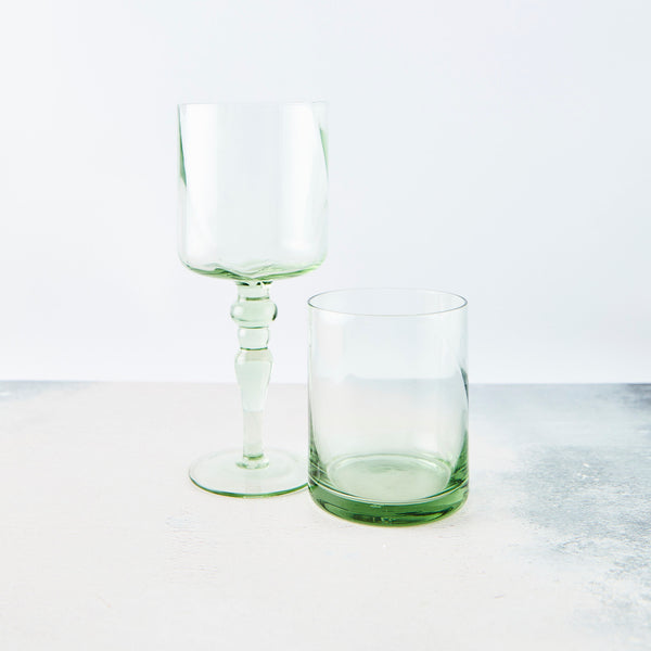 Clear light green wine glass and tumbler.