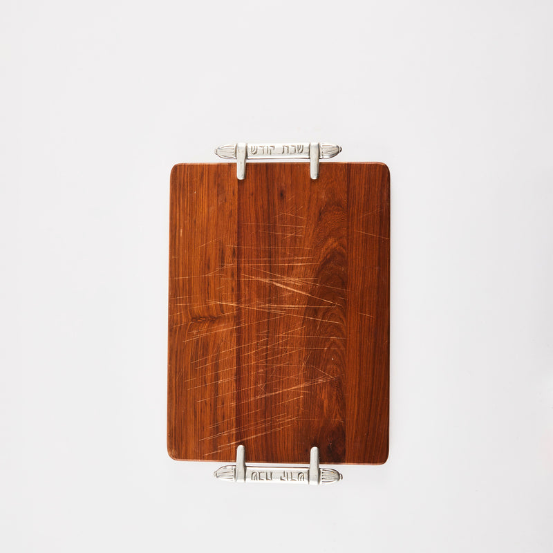 Dark wooden board with metal handles and Jewish Hebrew Writing Shabbat Shalom Challah Bread Board.