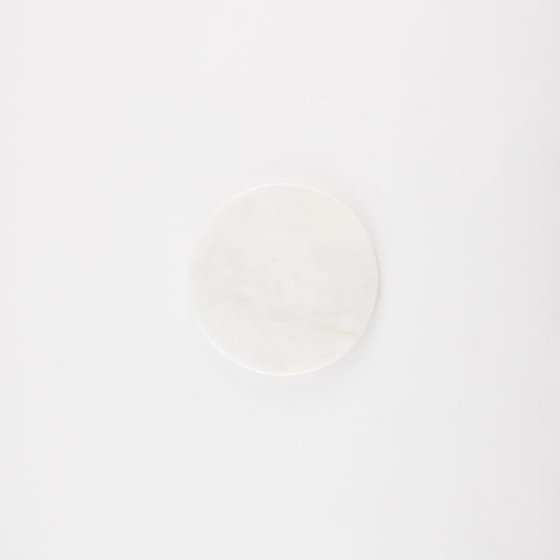 Circular white marble board.