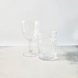 Clear glass embossed tumbler and wine glass.