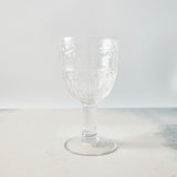 Clear embossed wine glass.