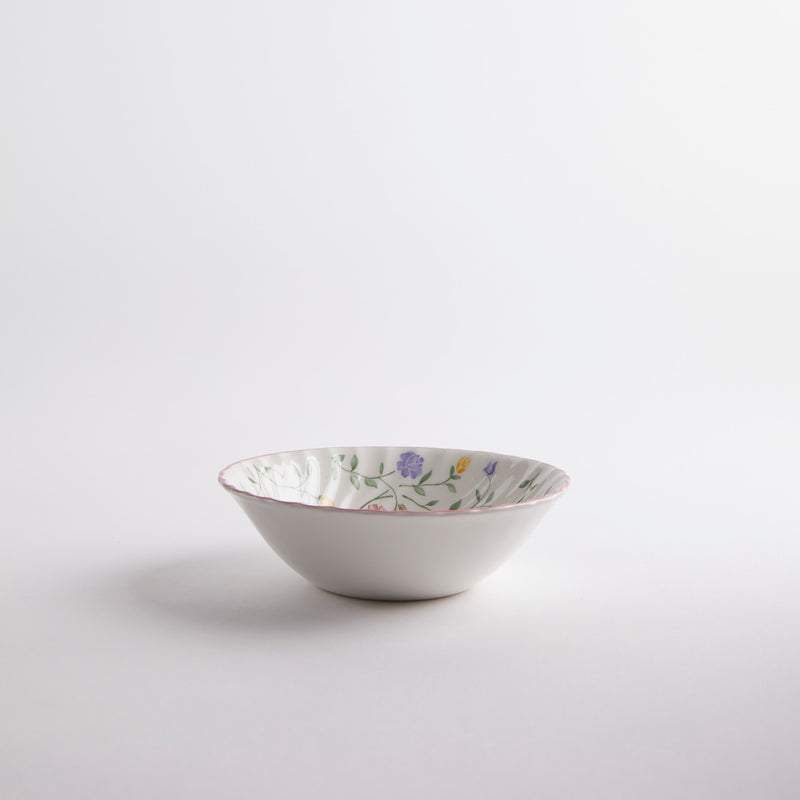 White bowl with multicoloured floral interior.