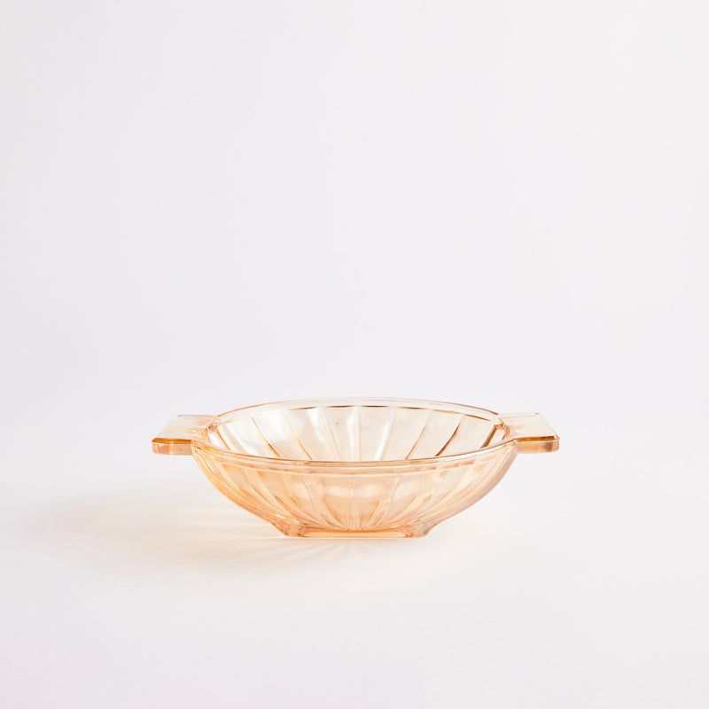 Vintage style medium peach coloured clear glass bowl with wave edge detailing.