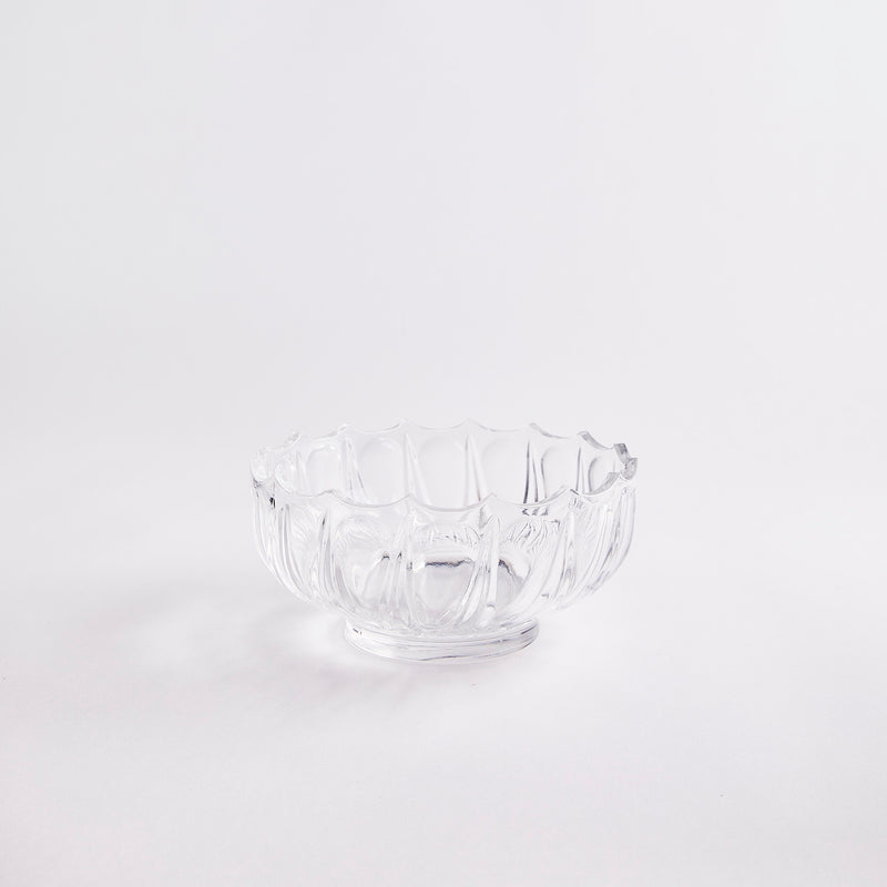 Clear glass bowl with scalloped edge.