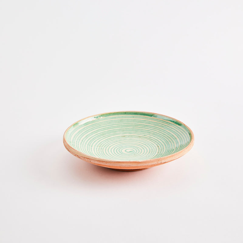 Terracotta bowl with inside green design.