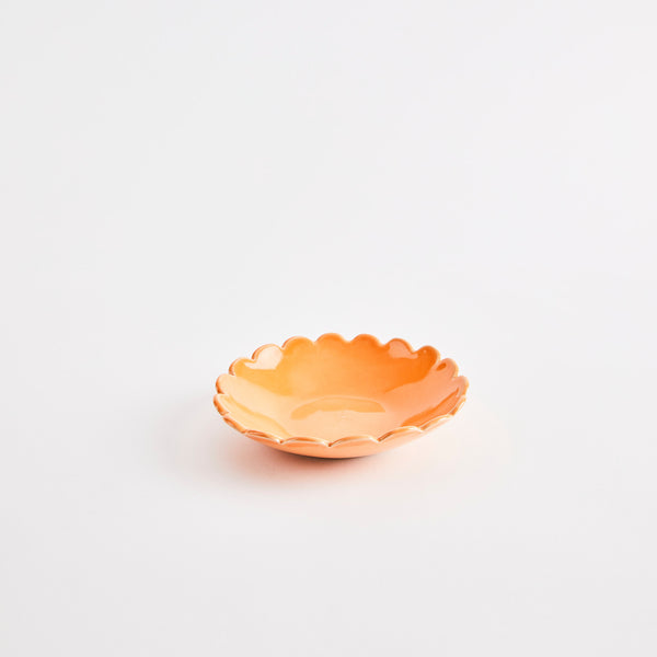 Orange scalloped edge bowl.