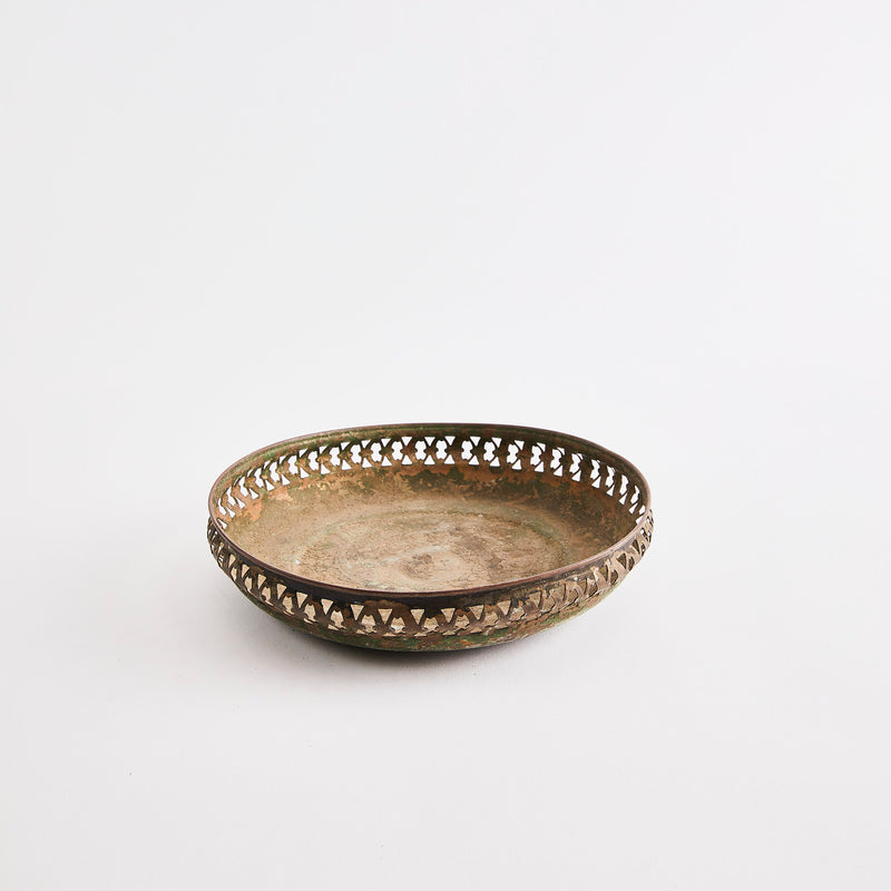 Metal bowl with intricate design edge.