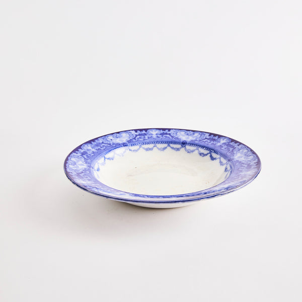 White bowl with blue vintage designed edge.