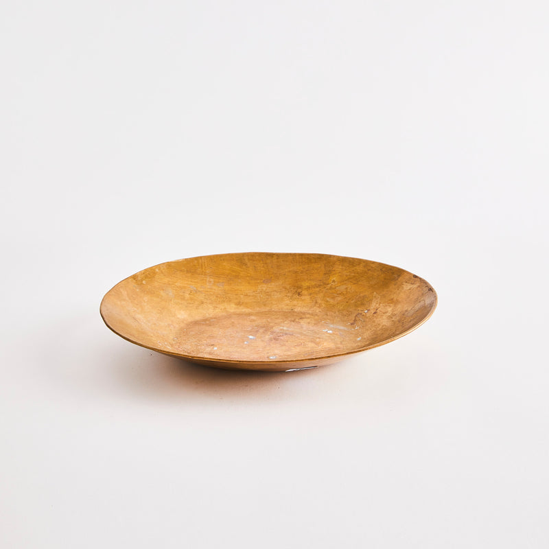 Worn gold bowl.