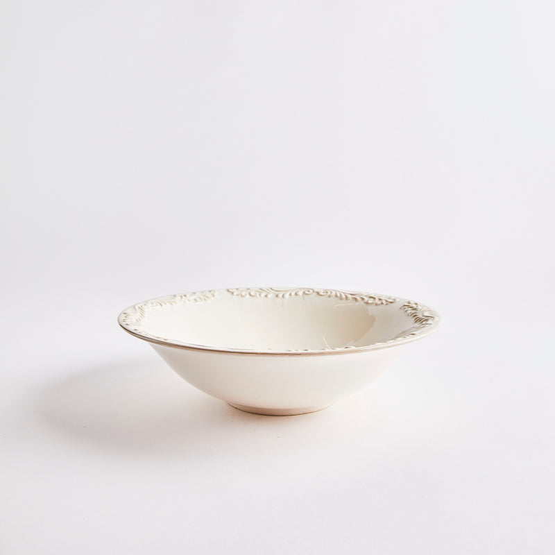 Cream bowl with embossed design rim.