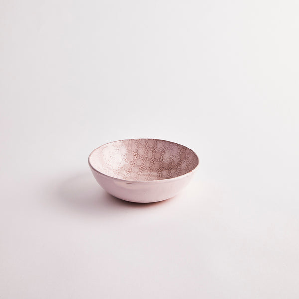 Light pink bowl with intricate interior design.
