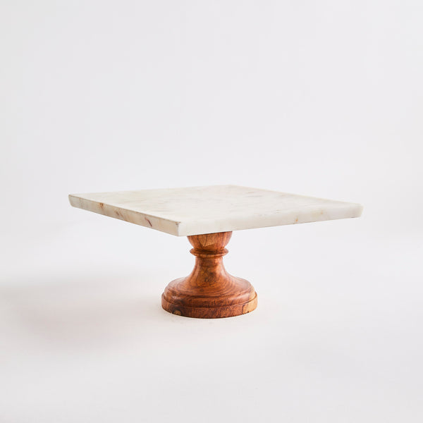 Marble top cake stand with wood base.