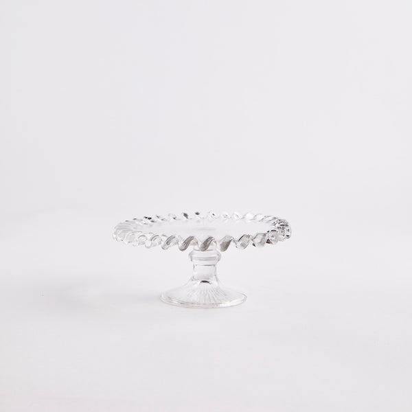 Clear glass with ruffled edges cake stand.