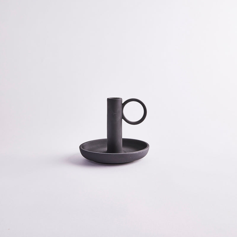 Black candle holder with handle.