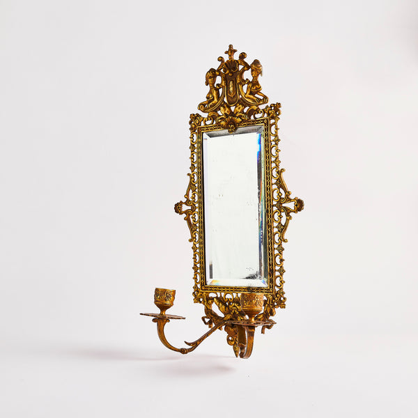 Brass intricate design frame mirror with candle holder.