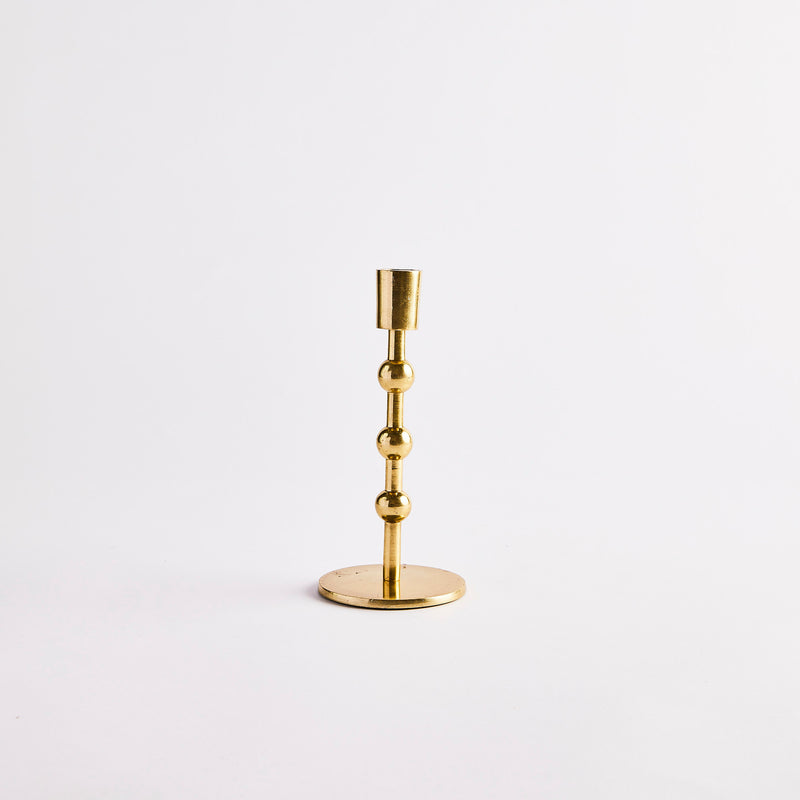 Gold circular tier candle holder.