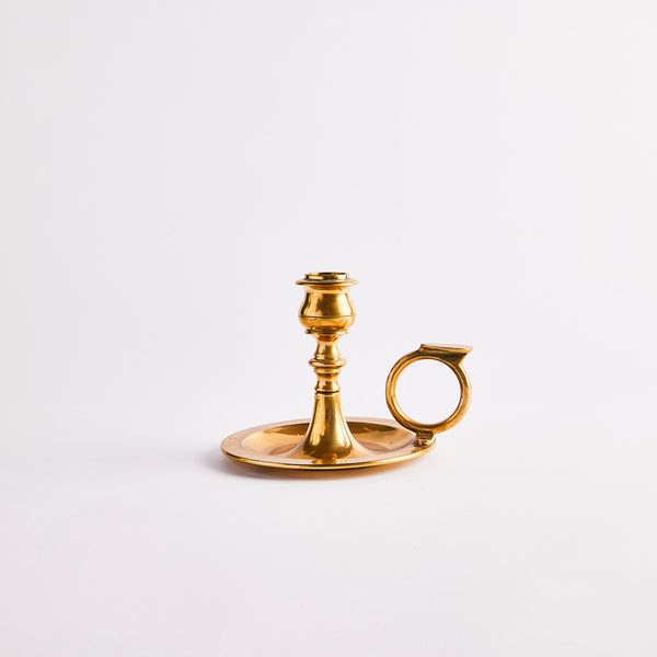 Gold candle holder with handle.