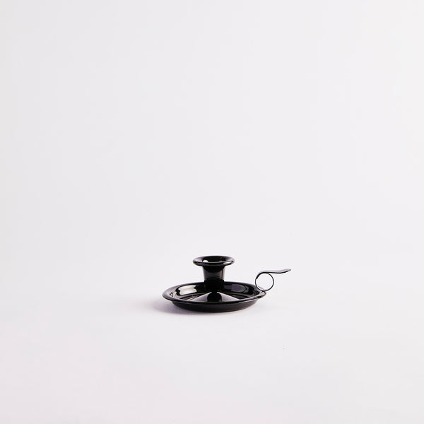 Black candle holder with handle.