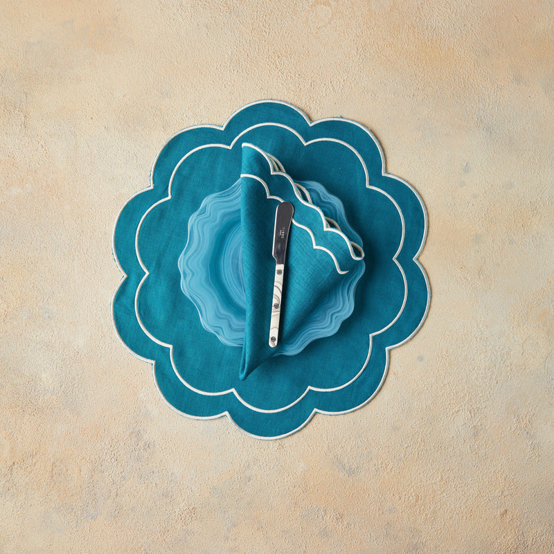 Top view of blue table setting with beige background.