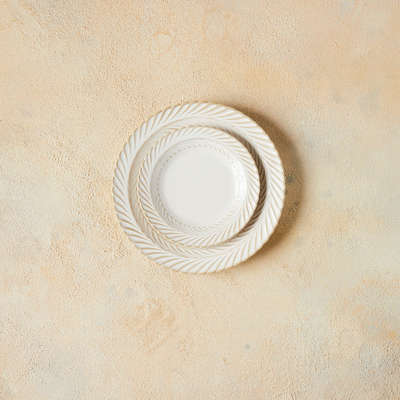 Top view of white plates on Cloudy Background.