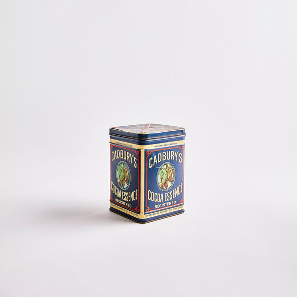 Navy vintage container with Cadbury's Cocoa Essence Registered text. 