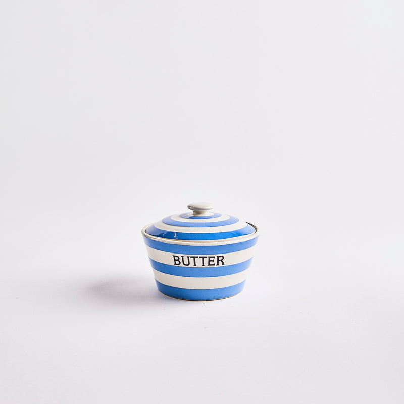 White and blue striped container with butter text.