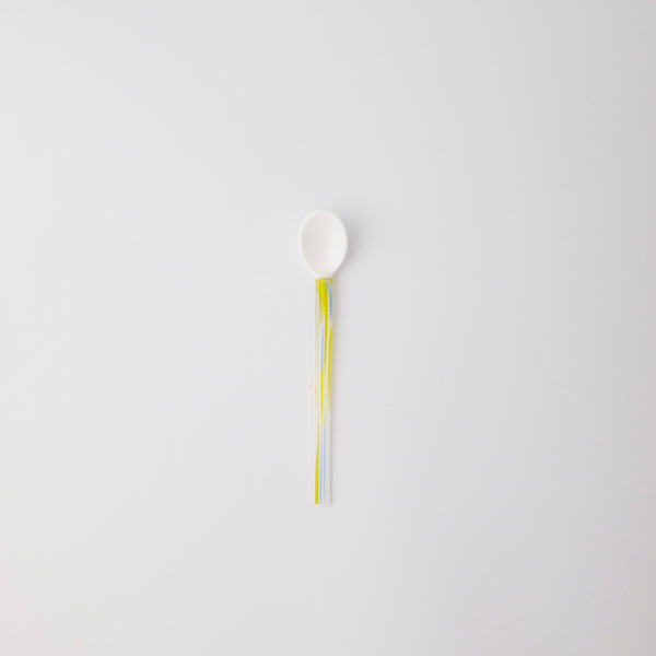 White with blue and yellow handle spoon. 