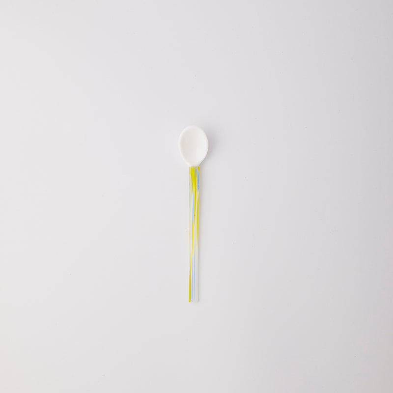 White with blue and yellow handle spoon. 