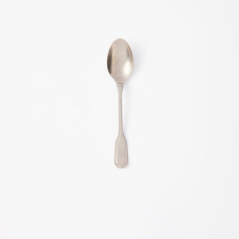 Brushed silver spoon.