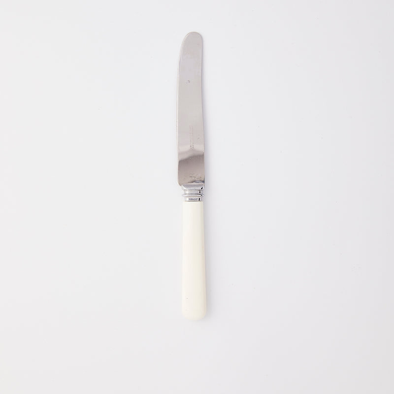 Silver with white handle knife.