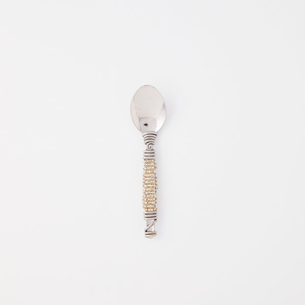 Silver spoon with gold detail handle.