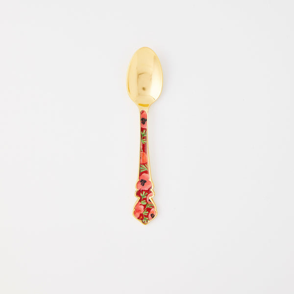 Gold spoon with red floral handle. 