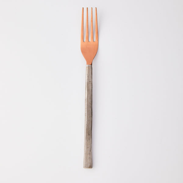 Bronze with silver handle fork.